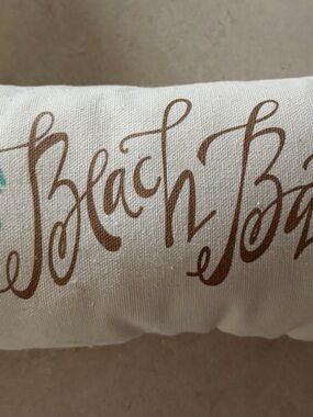 Decorative White Pillow with Brown Script